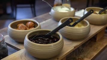 A wooden table with several ceramic bowls containing different foods.