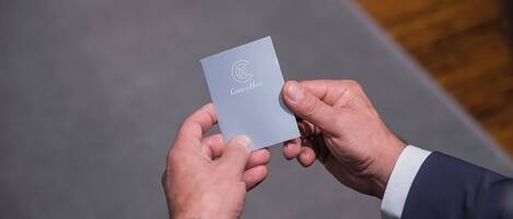 A person holding a card with the Century Hotel logo.
