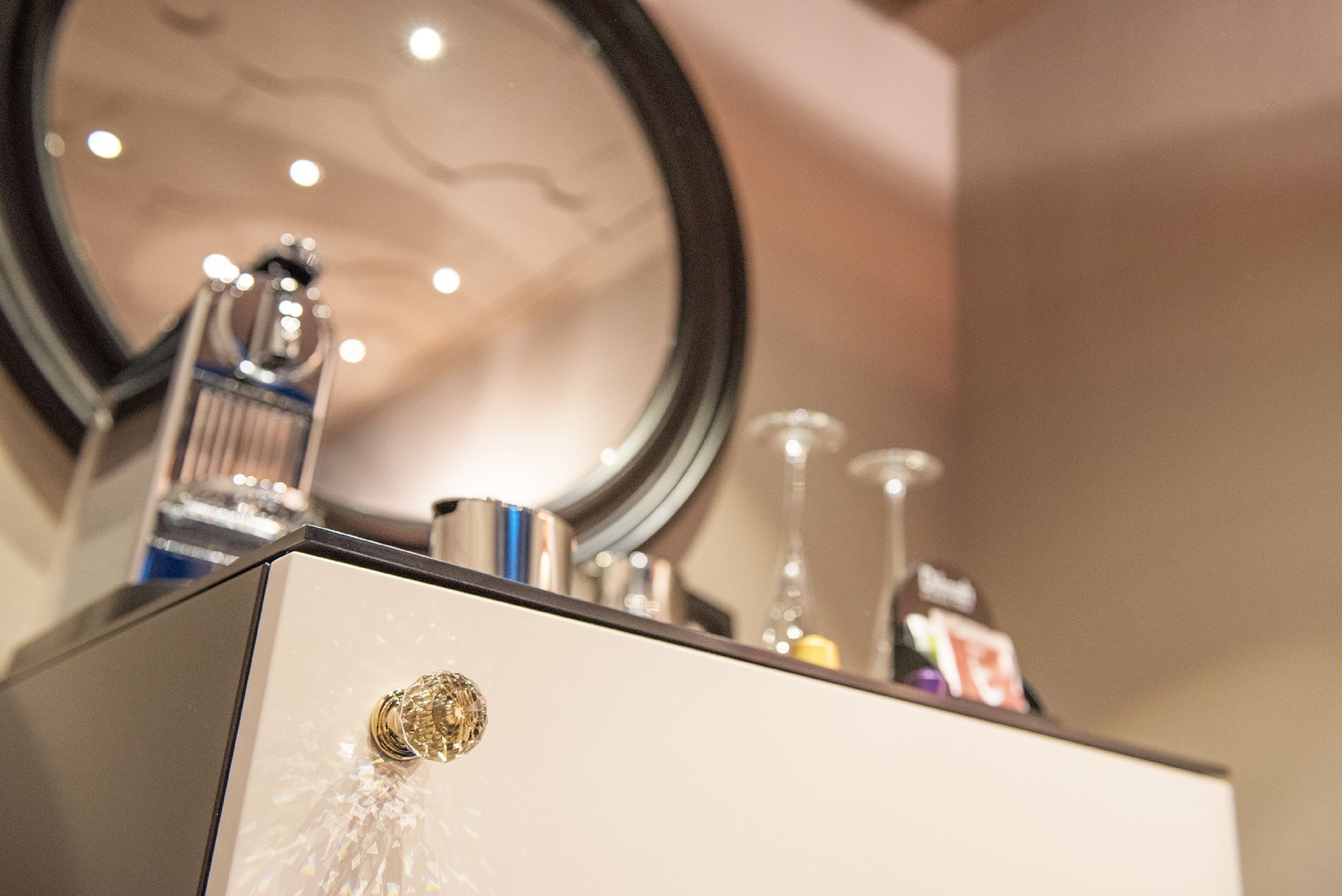 A bathroom vanity with a mirror, a faucet, and a sink.