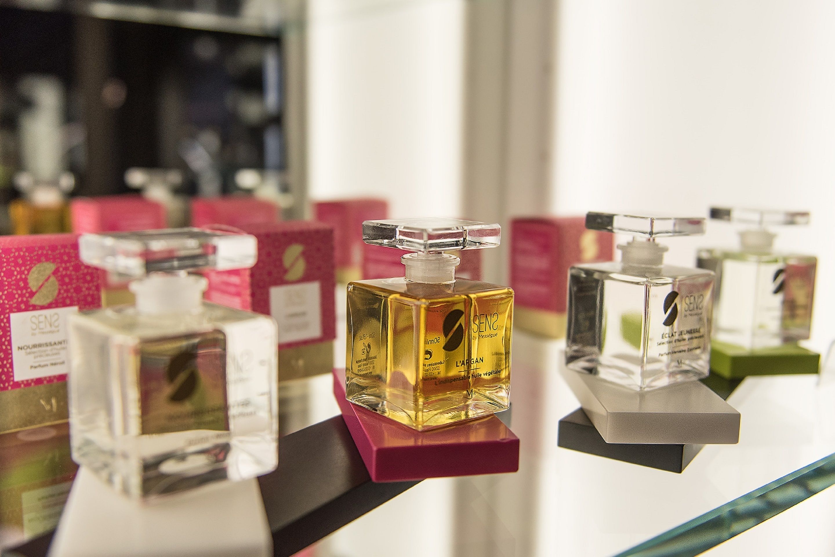 A display of perfume bottles on a shelf.