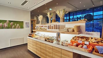 A breakfast buffet with various food items and a coffee station.