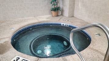 Relax in the hot tub, surrounded by a tranquil atmosphere and lush greenery.