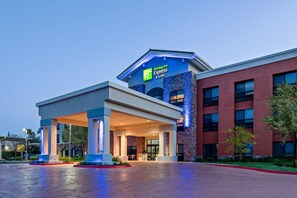 A Holiday Inn Express & Suites building with a covered entrance, large windows, and a brick facade. - Holiday Inn Express Hotel & Suites Atascadero by IHG (Atascadero)