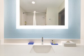 A bathroom with a large mirror, a sink, and a shower. - Holiday Inn Express Hotel & Suites Lavonia by IHG (Lavonia)
