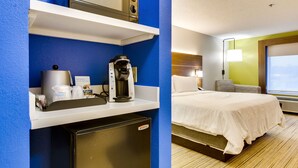 A hotel room with a bed, a desk with a coffee maker, a microwave, and a mini-fridge. - Holiday Inn Express Vincennes by IHG (Vincennes)