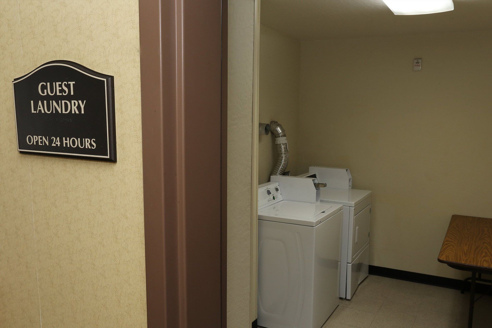 A guest laundry area with a sign indicating it's open 24 hours.