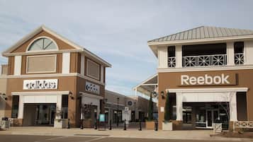 A commercial building with storefronts for Adidas and Reebok.