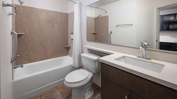 A modern bathroom with a bathtub, toilet, and sink.