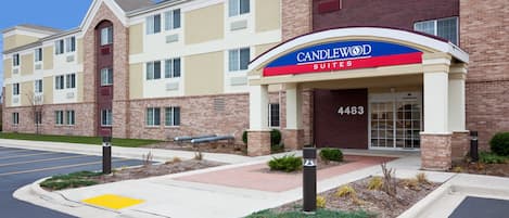 A hotel entrance with a sign reading 'CANDLEWOOD SUITES' and the number 4483.