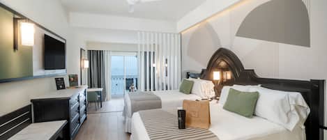 A modern hotel room with a large bed, a desk, and a seating area.