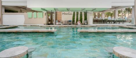 A pool area with a bar and seating.