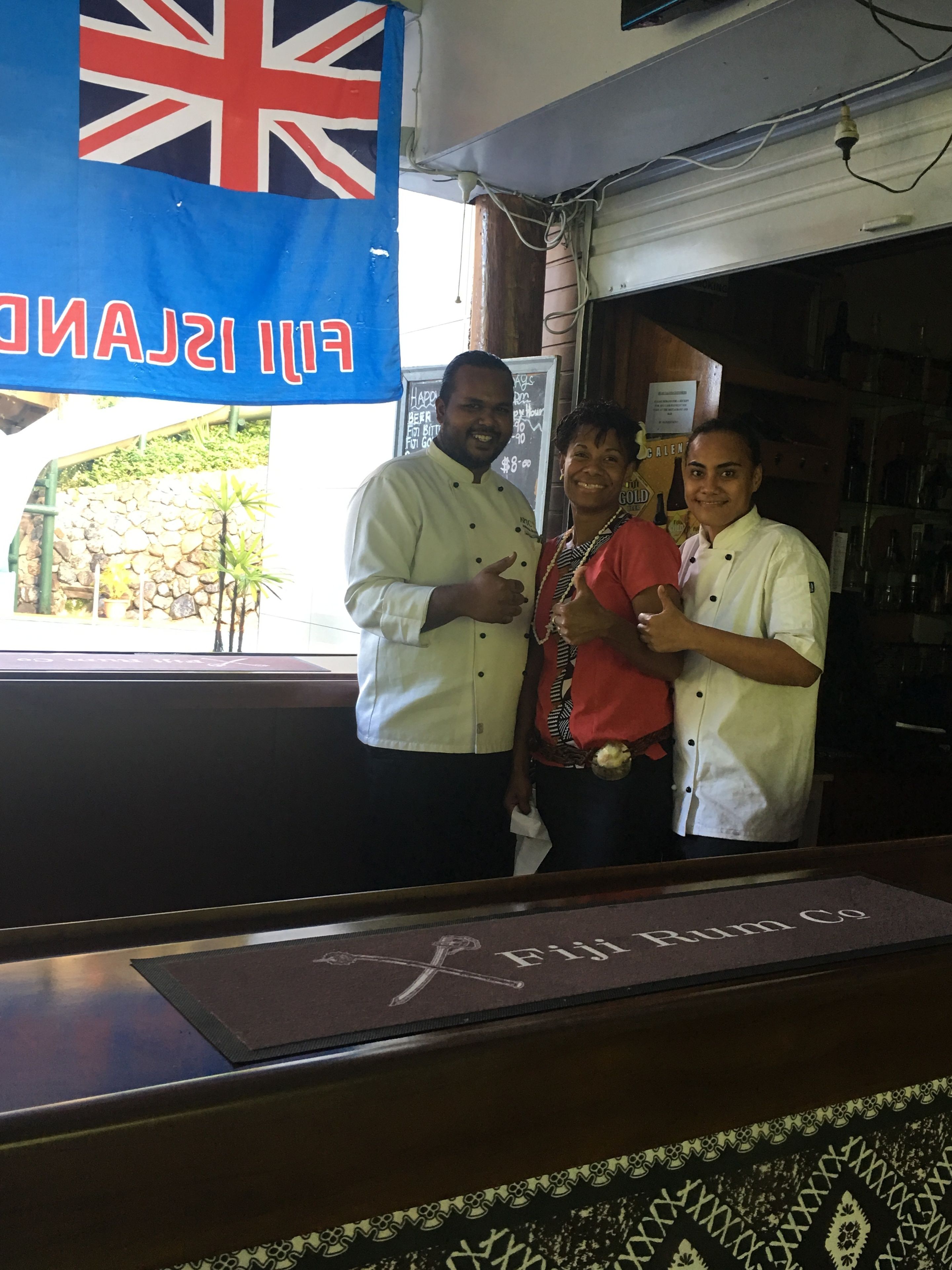 A bar with a sign reading "HAPPY ISLAND COASTLINE" and a flag above.