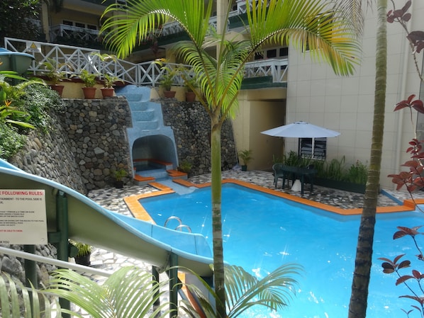 Outdoor pool, open 7:00 AM to 7:00 PM, pool umbrellas, sun loungers