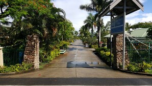 A pathway leading to a gated area with a sign for Grand Western Villas. - Grand West's Villas (Nadi)