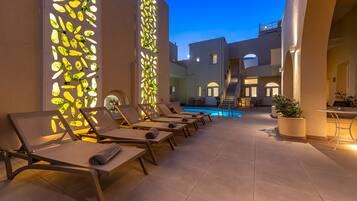 Seasonal outdoor pool, open 10:00 AM to 7:00 PM, pool umbrellas