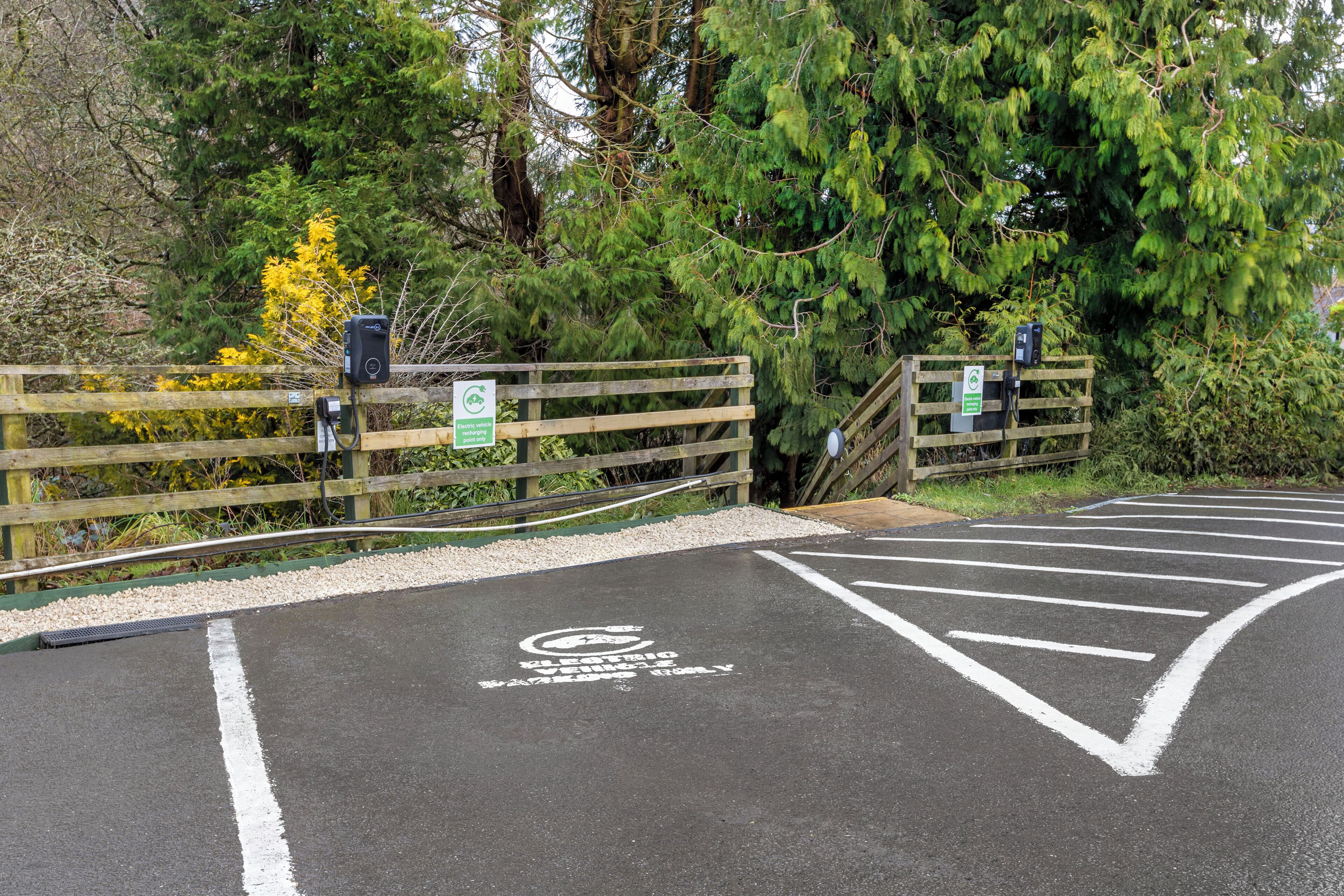 A parking area with a disabled parking sign and a wheelchair symbol.