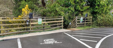 A parking area with a disabled parking sign and a wheelchair symbol.
