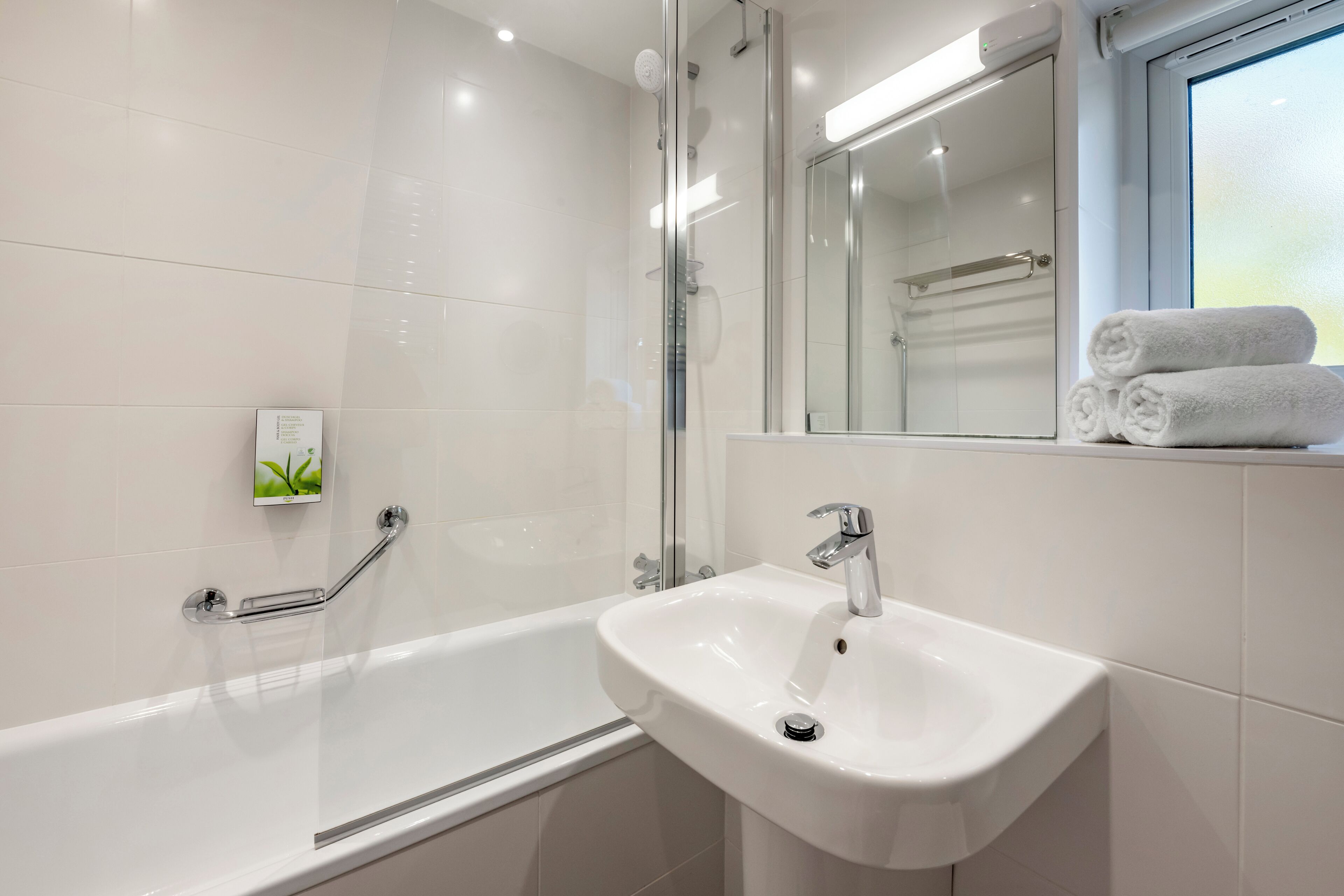 Une salle de bain moderne avec une baignoire, un lavabo et une douche à l’italienne.