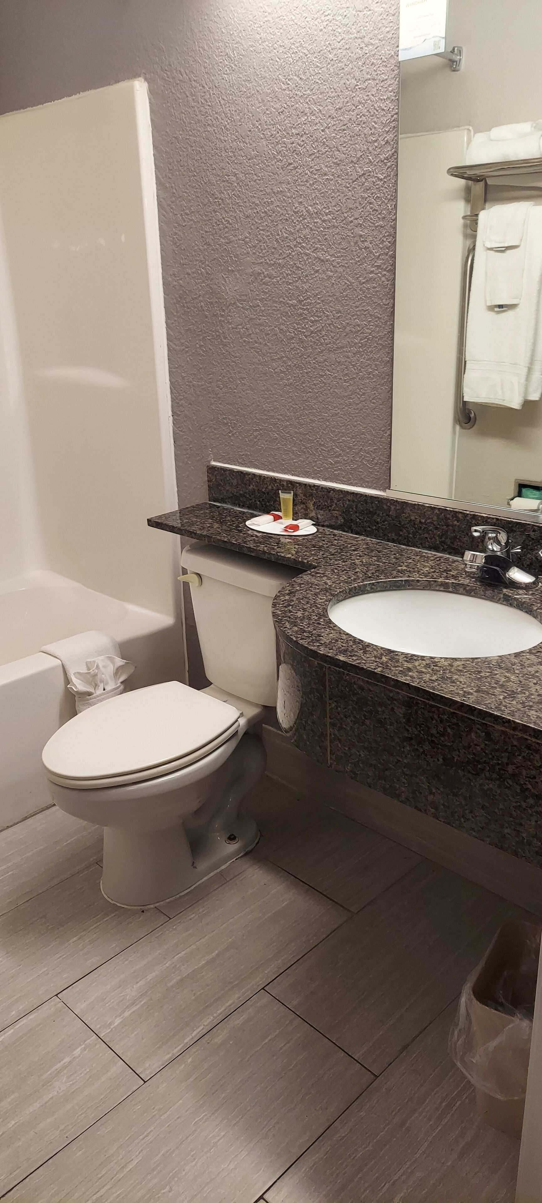 A bathroom with a toilet, sink, and bathtub.