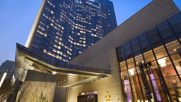 A modern building with a prominent glass facade and a large entrance area. - Grand Millennium Beijing (Beijing)