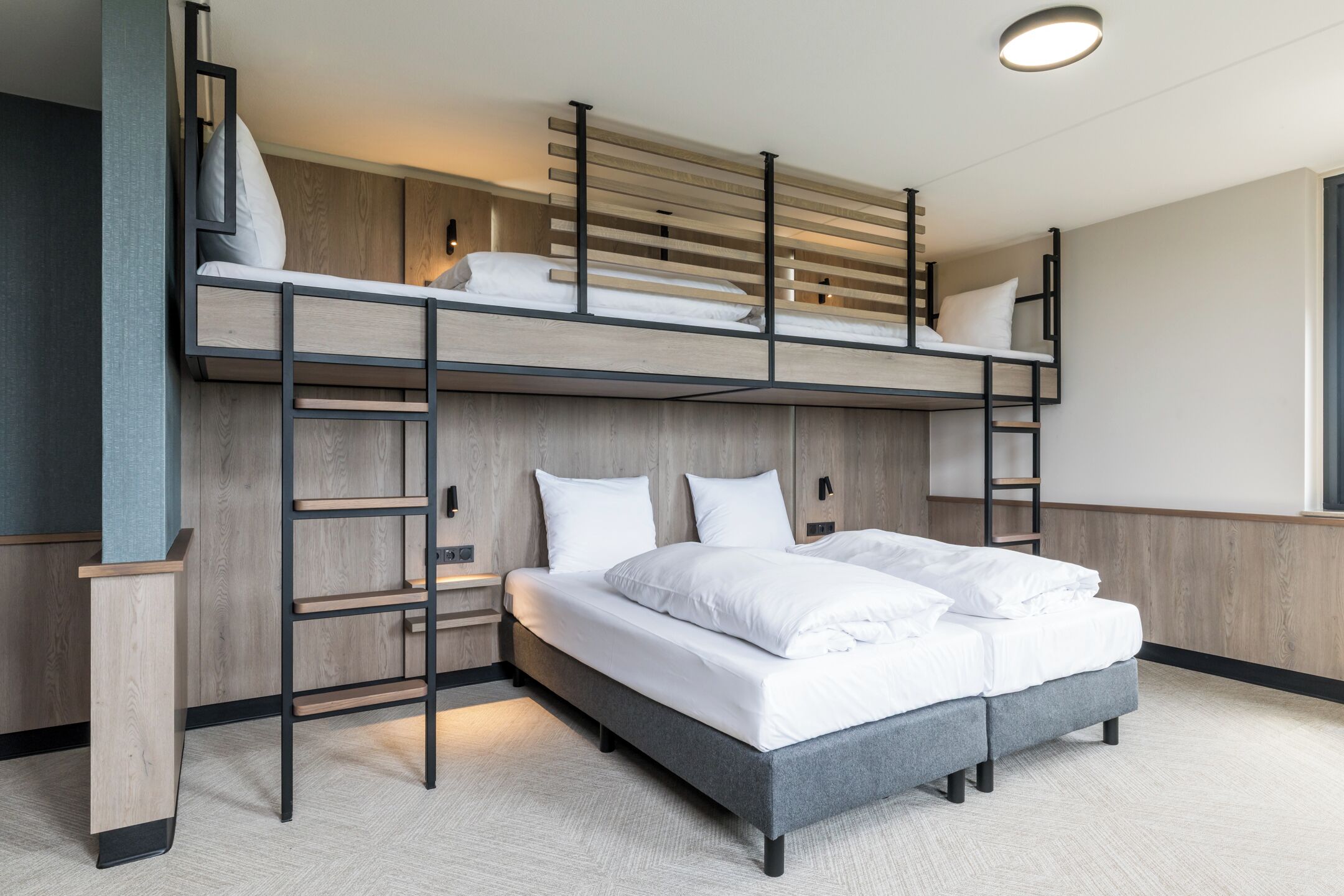 A bunk bed with a ladder, a bedside table, and a headboard.
