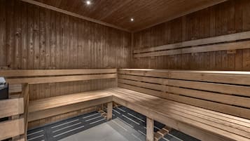 A sauna with wooden benches and a tiled floor.