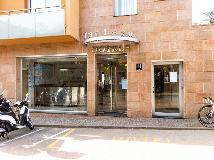 A hotel entrance with a sign reading "Turissa Hotels".
