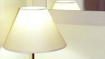 A lamp with a conical shade in a room.