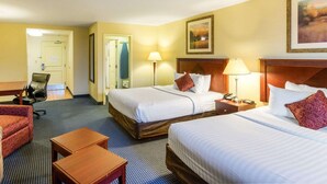 A hotel room with two beds, a desk, a chair, and a small table. - MainStay Suites Dover (Dover)