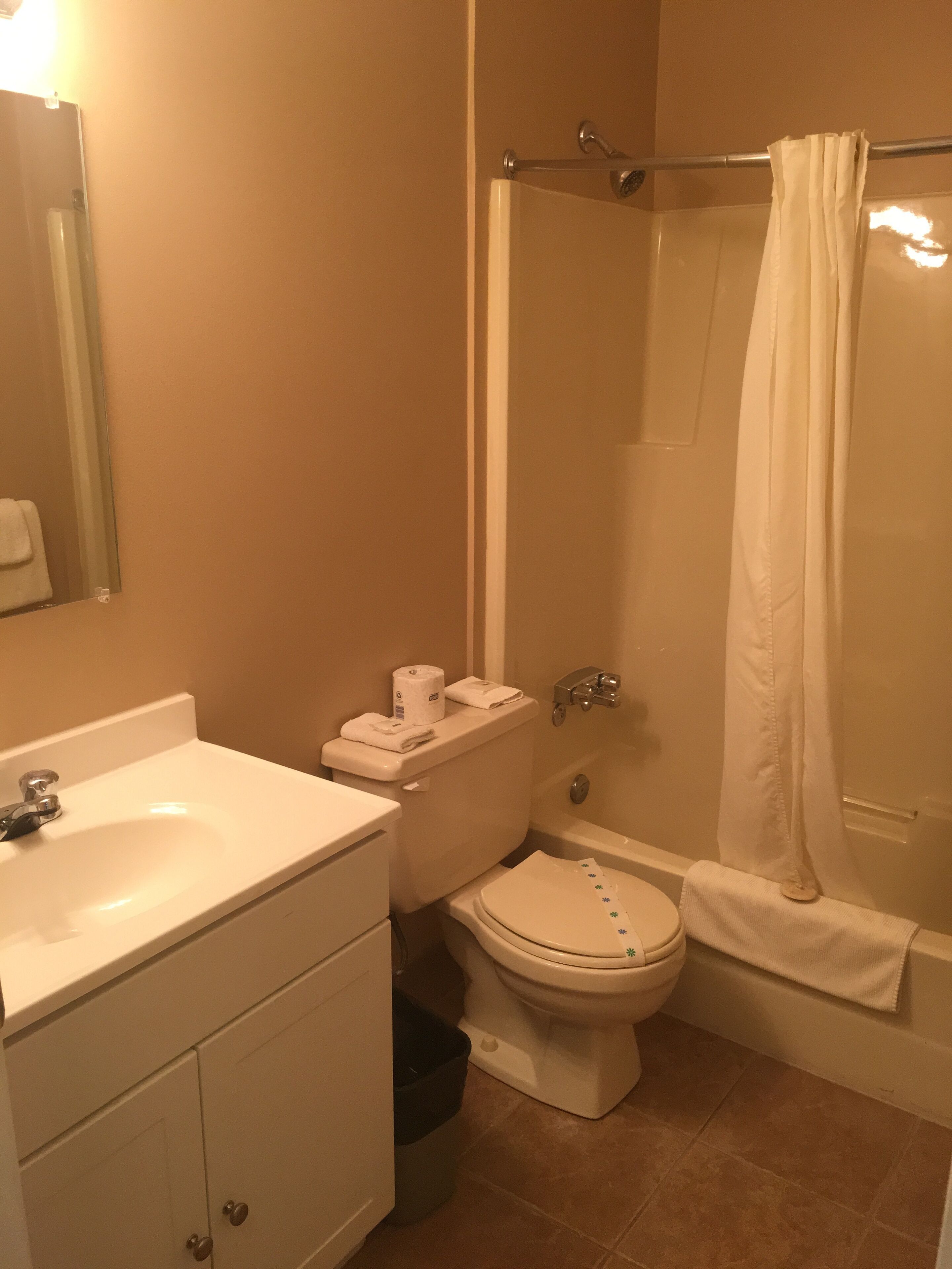 A bathroom with a sink, toilet, and bathtub.
