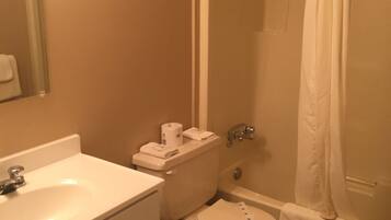 A bathroom with a sink, toilet, and bathtub.