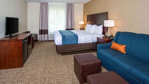 A hotel room with a bed, a TV, a desk, a sofa, and two lamps. - Comfort Inn Naugatuck-Shelton, CT (Naugatuck)