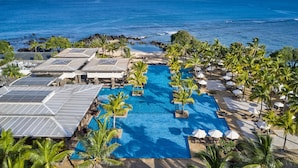 A resort with a swimming pool, solar panels, and a view of the ocean. - The Westin Turtle Bay Resort & Spa, Mauritius (Balaclava)