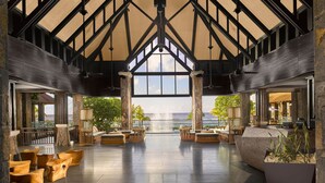 A spacious lobby with a high ceiling, large windows, and a view of the ocean. - The Westin Turtle Bay Resort & Spa, Mauritius (Balaclava)