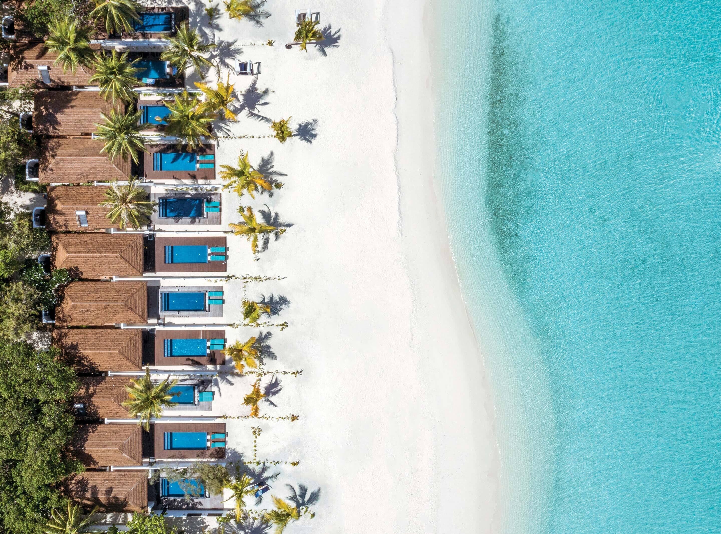 A resort with multiple overwater bungalows, each with a private pool and a beach view.