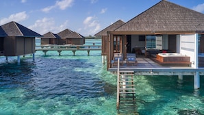 Overwater bungalows with clear blue water, wooden decks, and a hot tub. - Villa Nautica Paradise Island Resort (Lankanfinolhu)