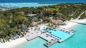 An aerial view of a resort with a large pool, beach, and ocean. - Villa Nautica Paradise Island Resort (Lankanfinolhu)