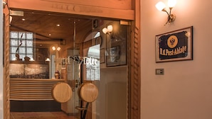 A hotel lobby with wooden flooring, a reception desk, and a sign reading "H.K. Post-Ablage". - Hotel Adler (Nova Levante)