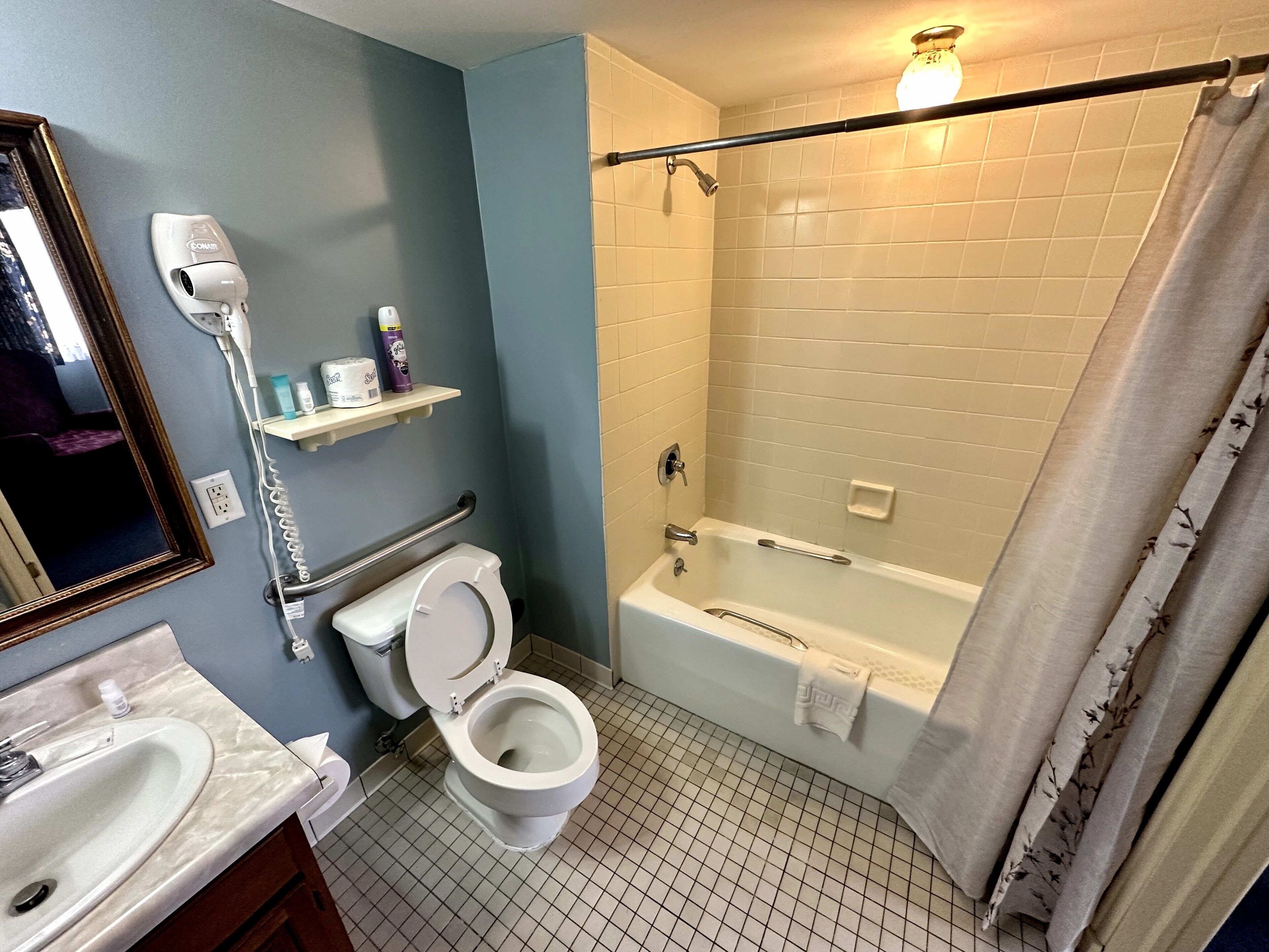 A bathroom with a toilet, sink, and bathtub.