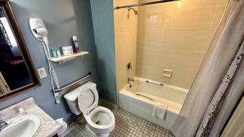 A bathroom with a toilet, sink, and bathtub.