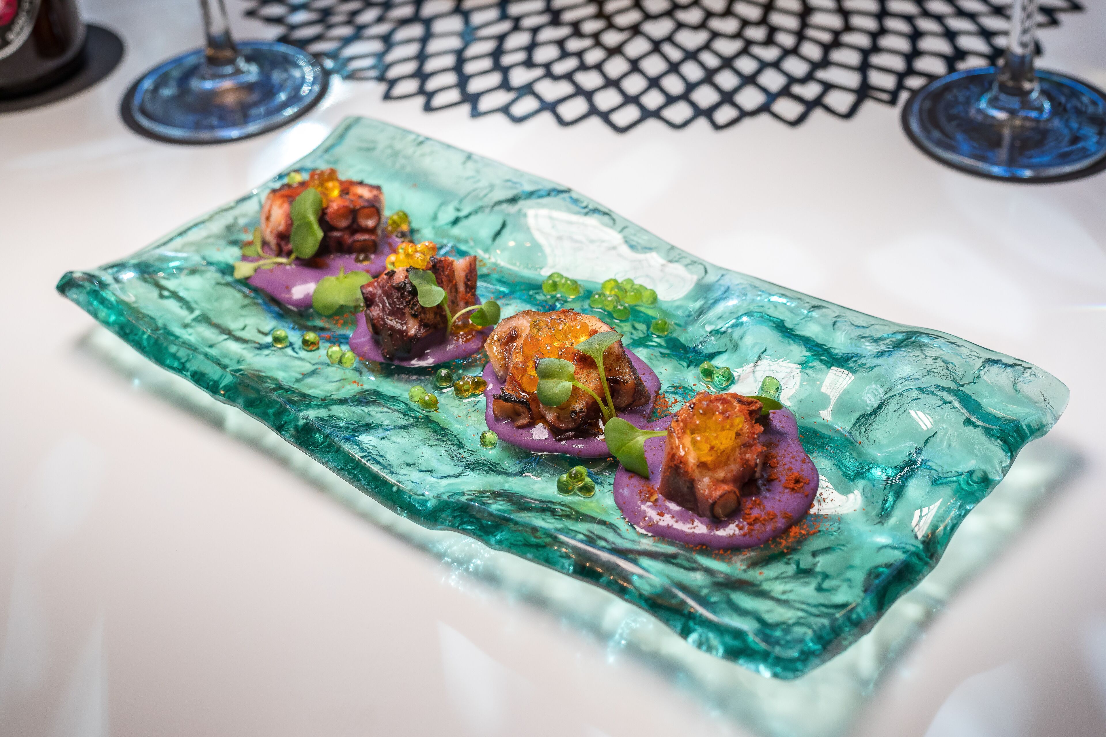A glass dish with food items.