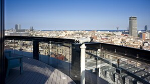 A rooftop terrace with a telescope, offering a panoramic city view.