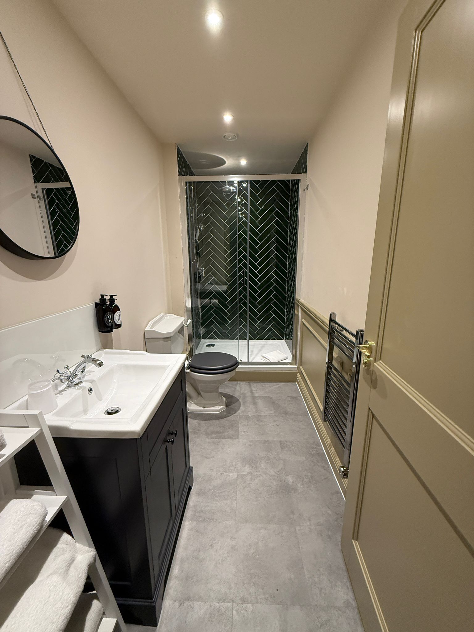 A modern bathroom with a bathtub, toilet, and shower area.
