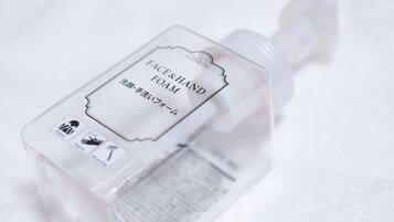 A bottle of face and hand foam with Japanese text and icons indicating use for face and hands.