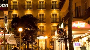 Un hotel con un llamativo letrero que dice 'KING', varios balcones y una entrada bien iluminada.