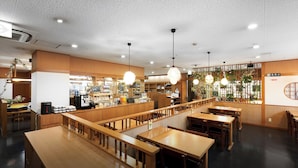 A restaurant interior with wooden furniture, pendant lighting, and a counter area. - Daiwa Roynet Hotel Kobe Sannomiya (Kobe)