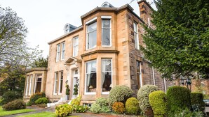 A large, historic building with multiple windows and a well-maintained garden. - Kildonan Lodge Hotel (Edinburgh)