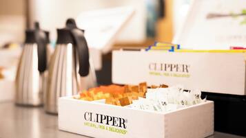 A box labeled 'CLIPPER' with a tagline 'NATURAL, FAIR & DELICIOUS' on a countertop.