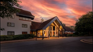 A hotel with a prominent clock tower, large windows, and a covered outdoor area. - Holiday Inn Hemel Hempstead M1, Jct. 8 by IHG (Hemel Hempstead)