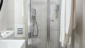 A modern bathroom with a glass-enclosed shower, a white toilet, and a sink with a mirror. - Vardar Palace Hotel - Special Class (Istanbul)